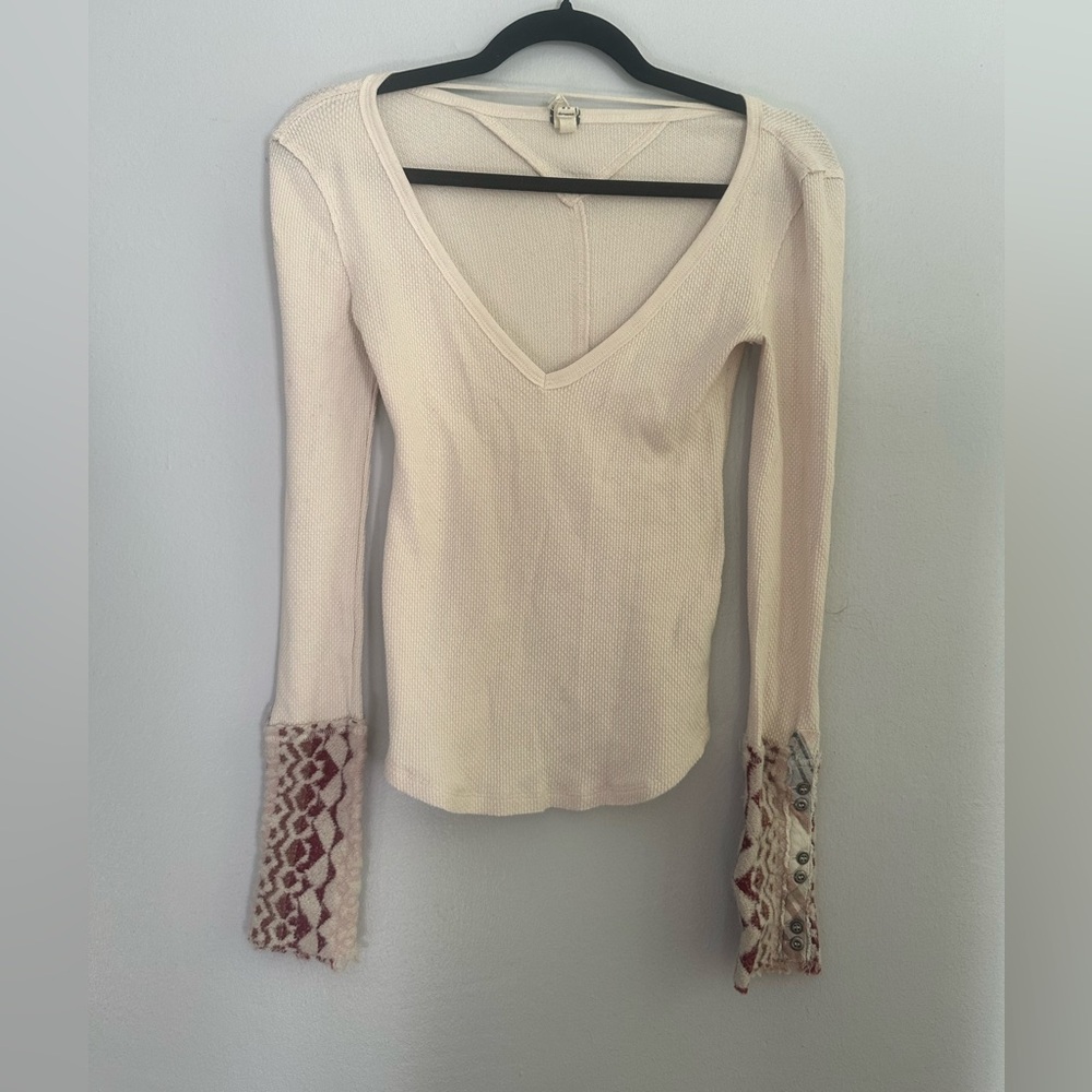 Free people white long sleeve shirt with design on the end of the sleeve